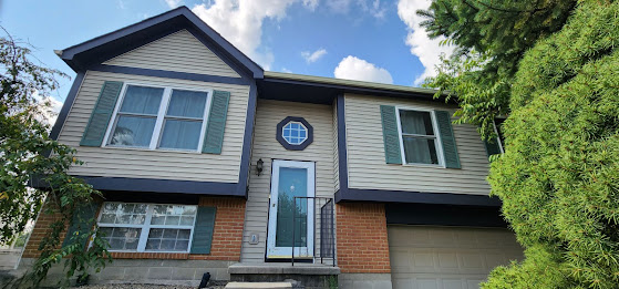 A two story house with a blue front door